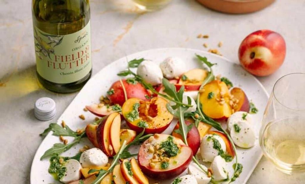Stone fruit Caprese salad with bocconcini and basil pesto drizzle